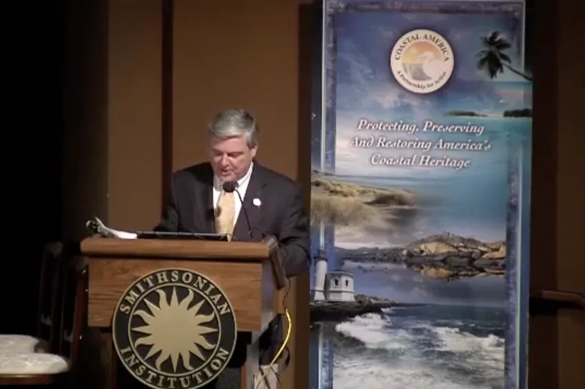 a man speaking at the podium