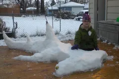 Sophi Bromenshenkel poses with a hammerhead shark snow sculpture.