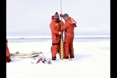 two scientists raise an ice core