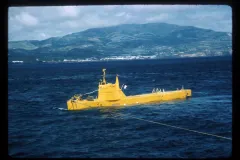 a yellow submersible at the ocean's surface