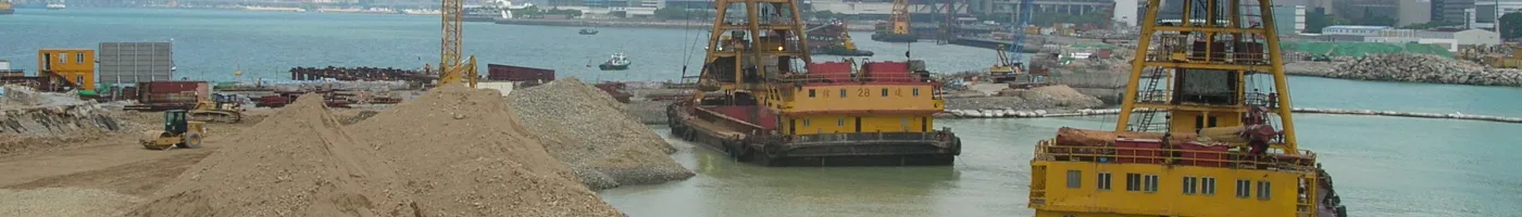 Large construction vehicles remove habitat from a beach. 