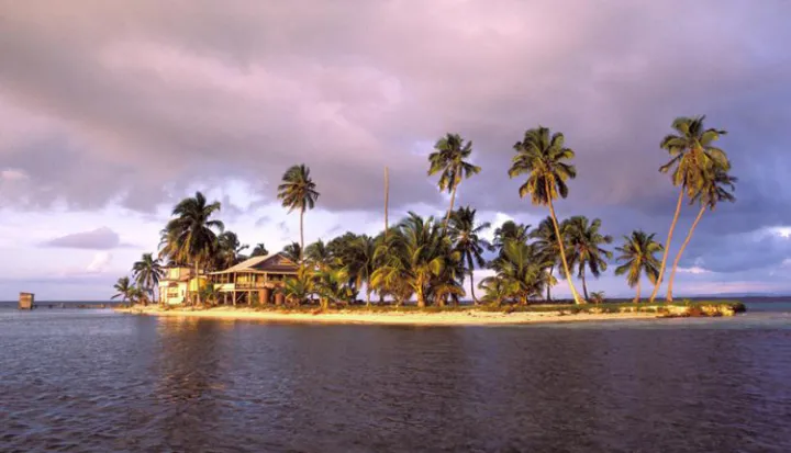 The sun sets over the Smithsonian’s marine field station at Carrie Bow Cay, Belize. For more than three decades, it has been home to the Smithsonian’s Caribbean Coral Reef Ecosystem Program.