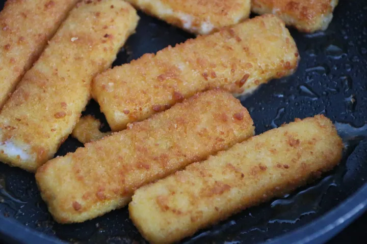 a pan of frying fish sticks