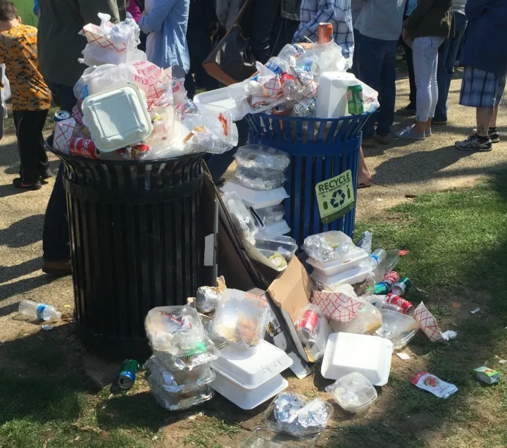 Two overflowing trashcans